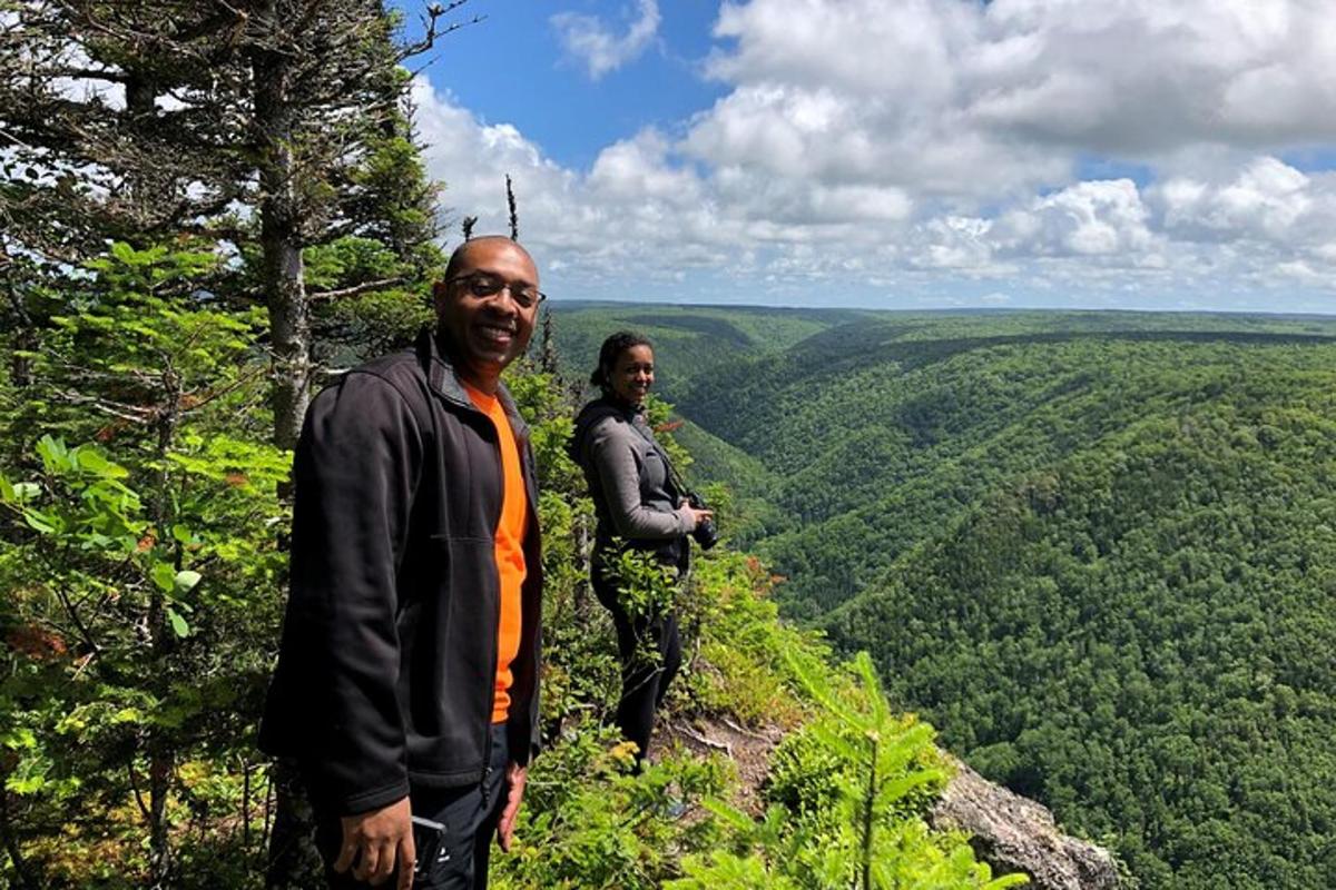 two men standing on top of a mountain
