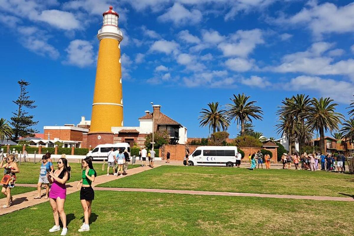 a group of people walking around a lighthouse