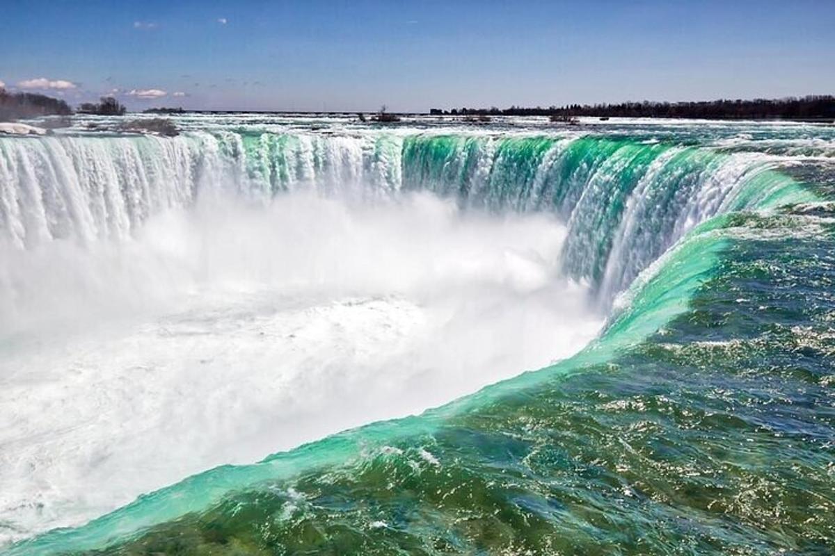 a large waterfall with green and white water