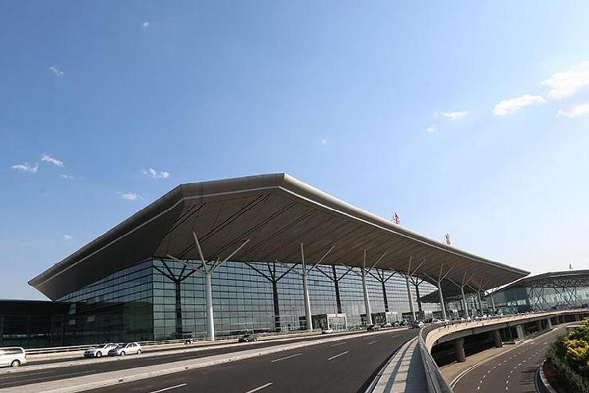 a large building with a roof on the side of a road