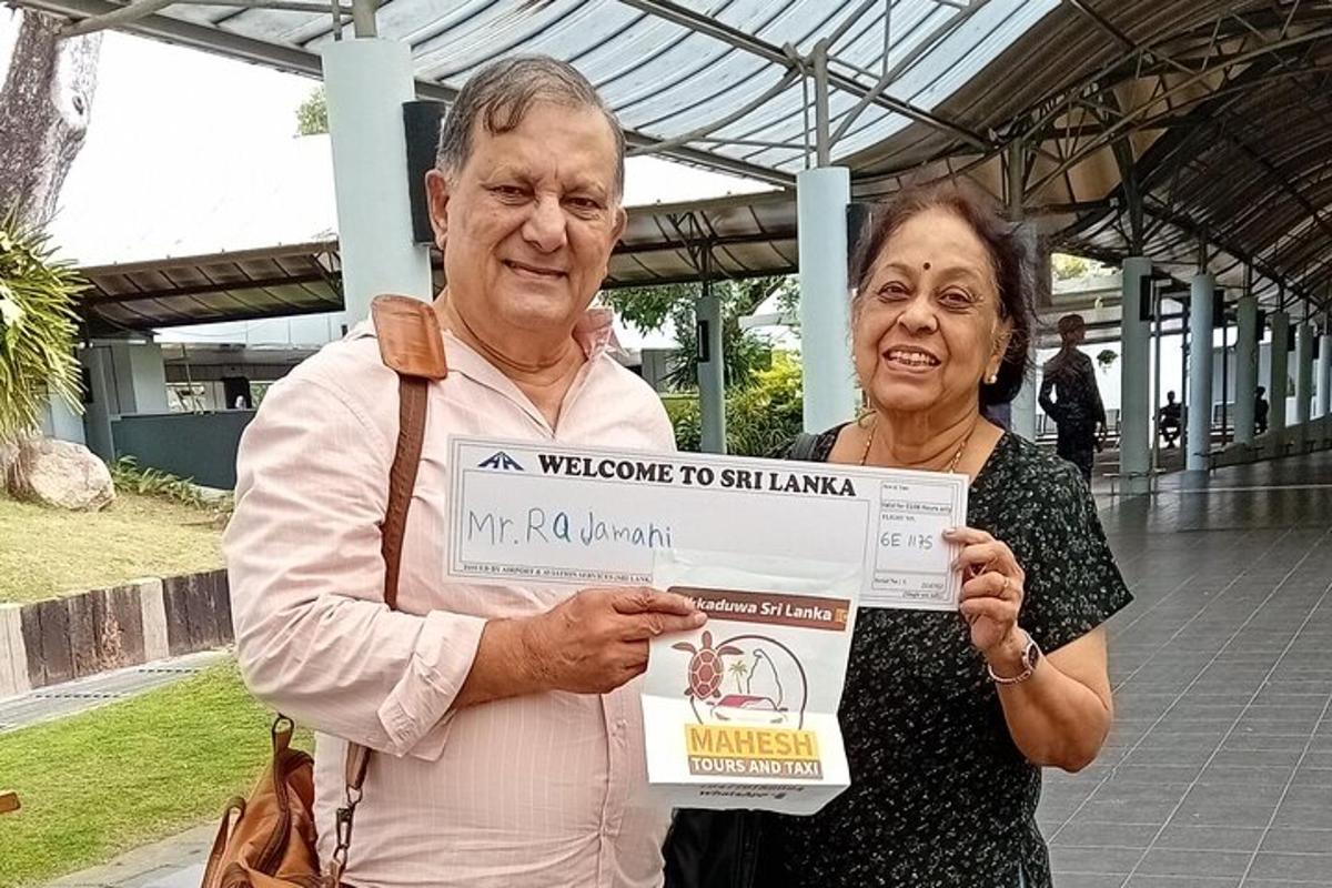 a man and a woman holding up a cheque
