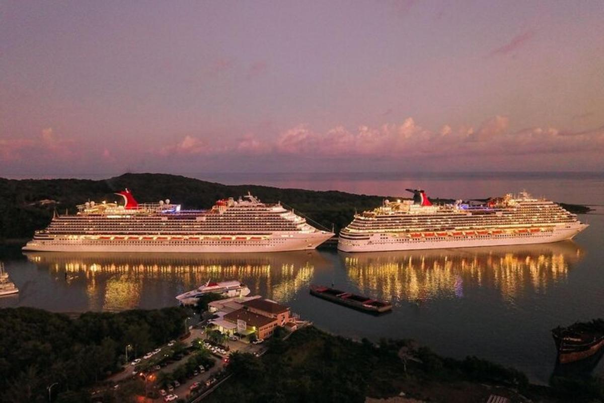 three cruise ships docked in the water at night
