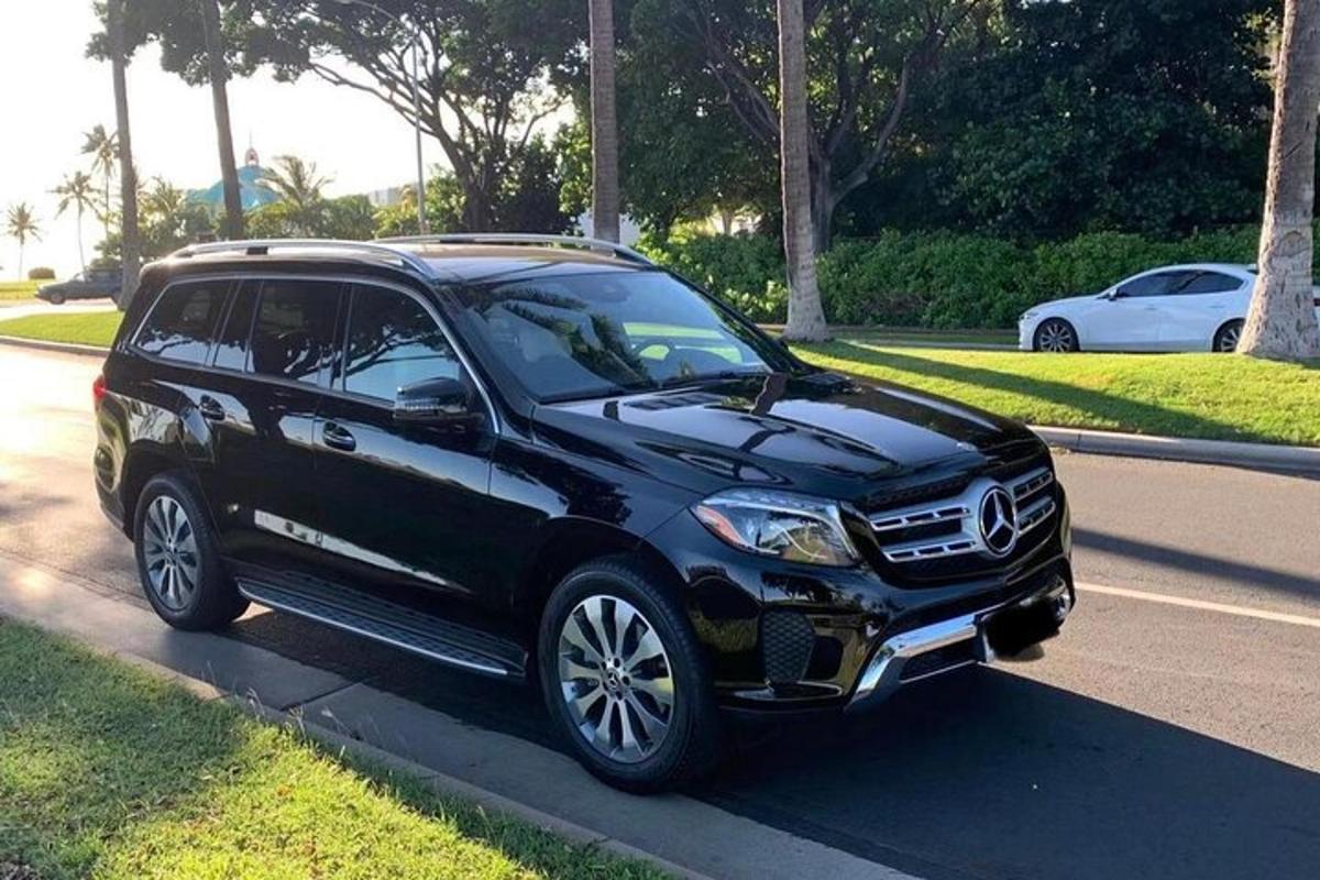 a black suv parked on the side of a street