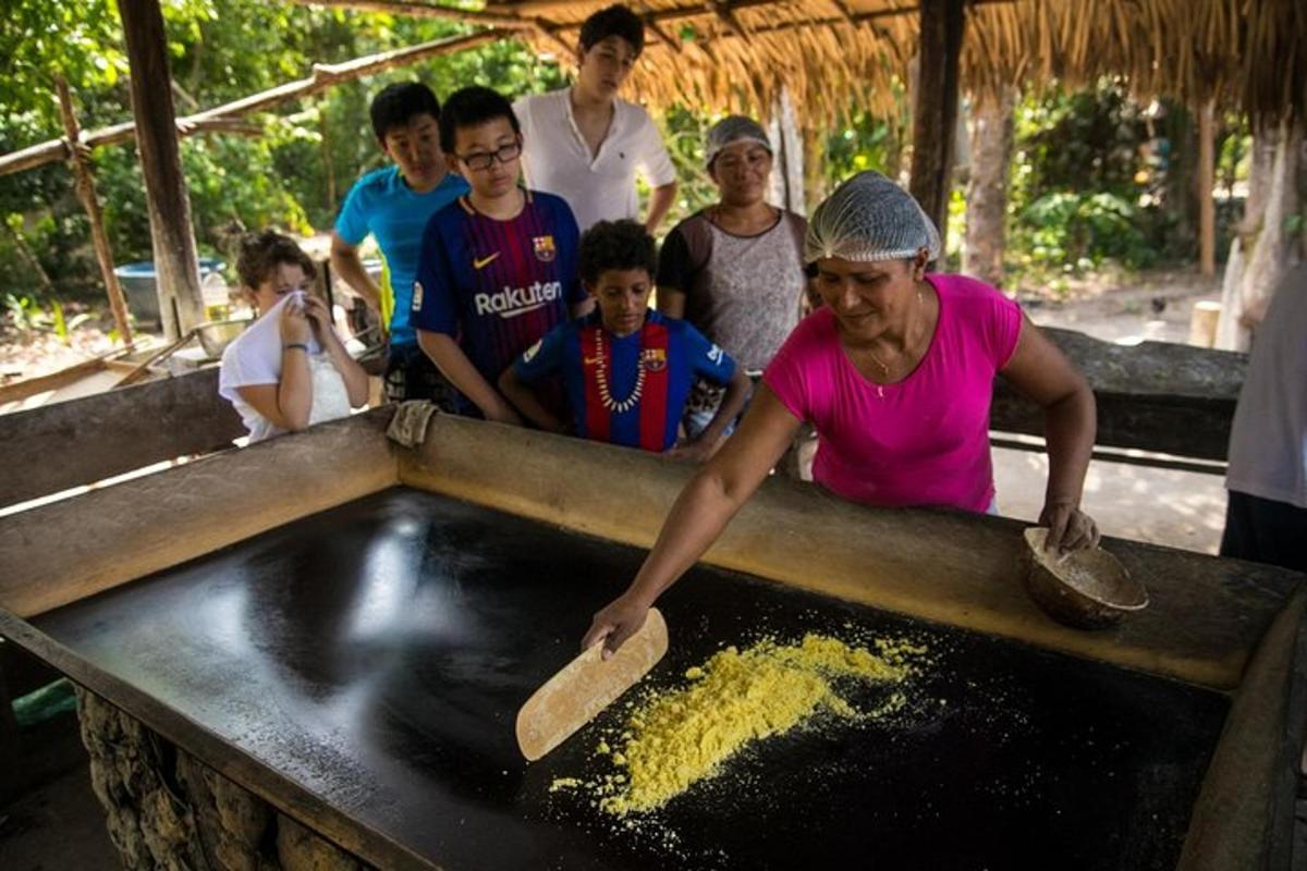 a woman preparing food in a mixing bowl with people