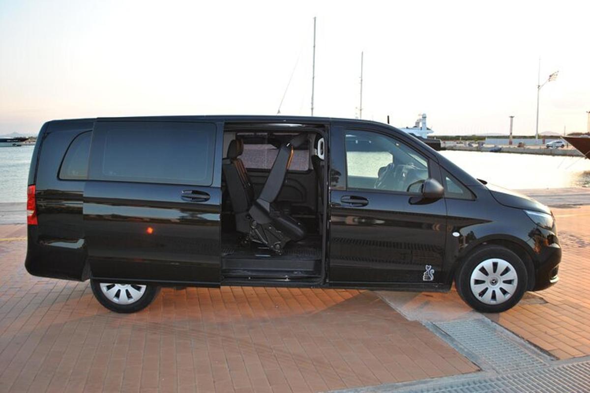 a black van parked in a parking lot with its door open
