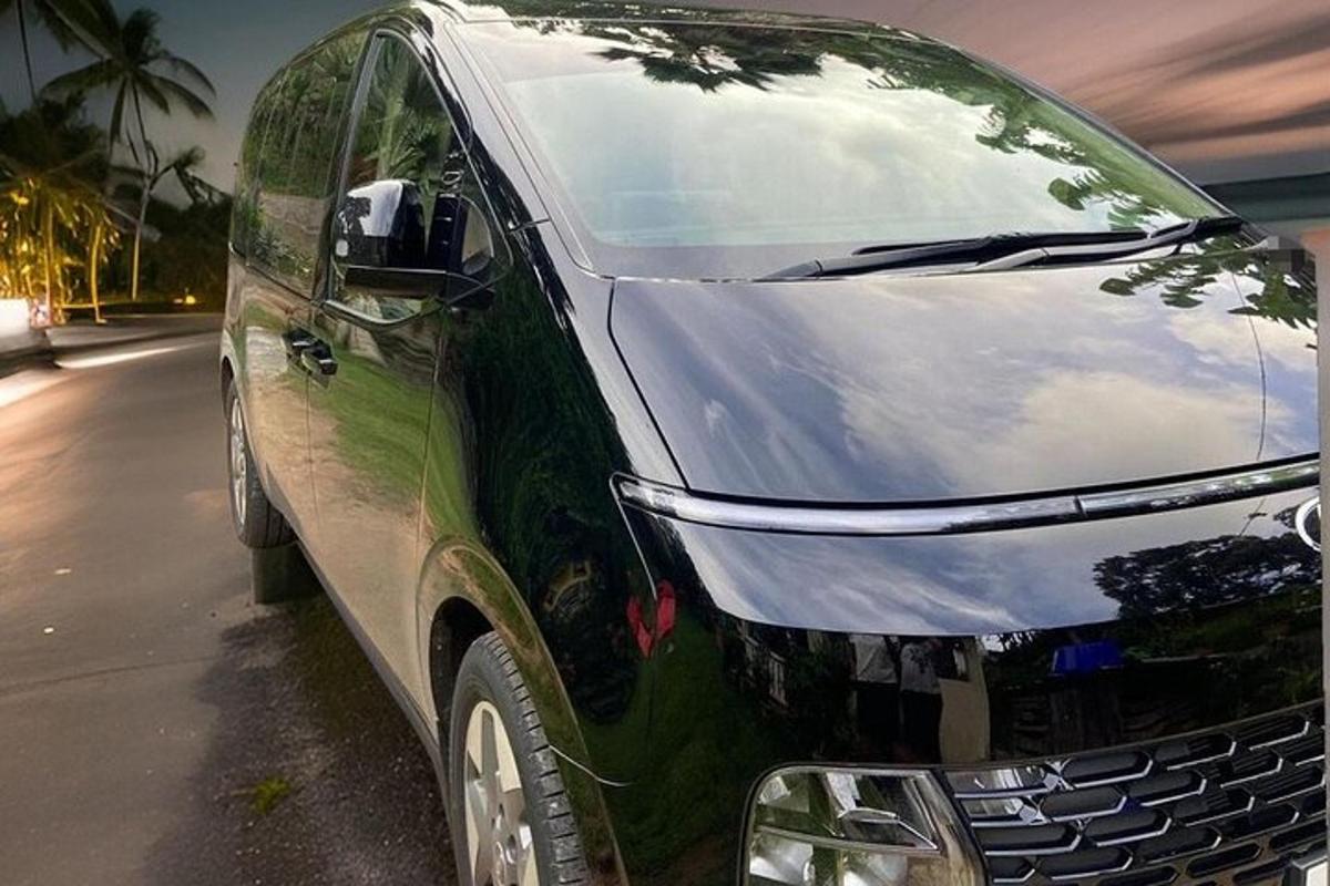 a green van parked on the side of a street