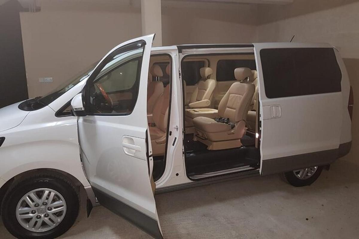 a white van with its door open in a garage