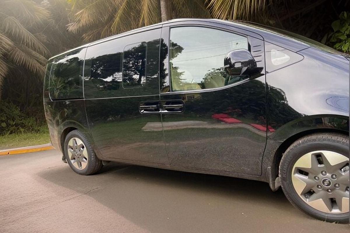 a black van with its door open on a street