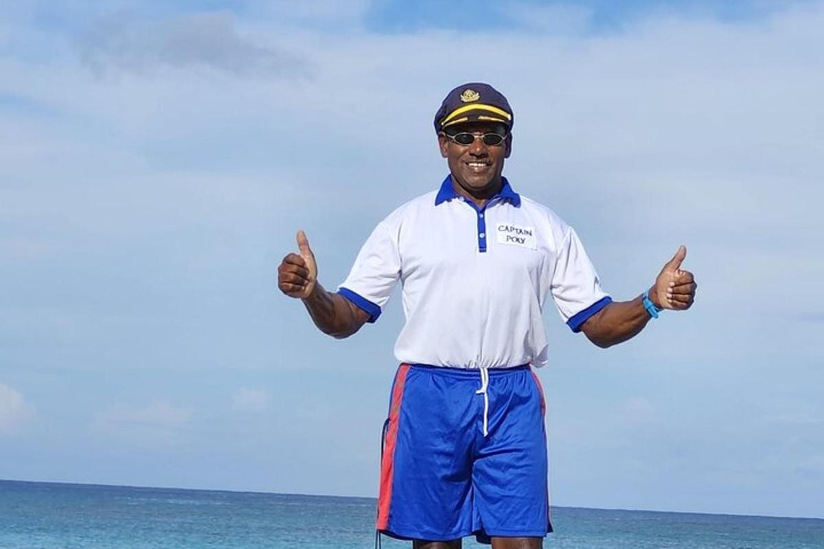 um homem parado na praia dando dois polegares para cima