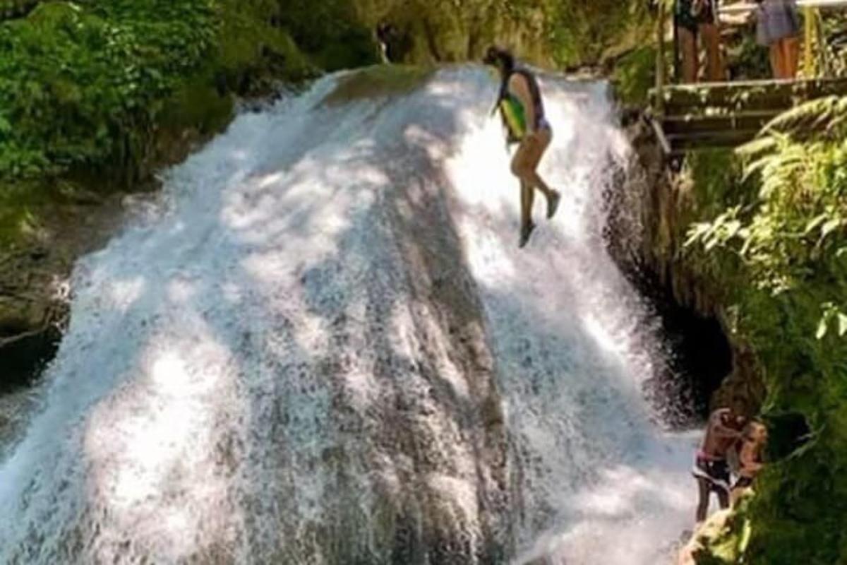 a man on a surfboard on a waterfall