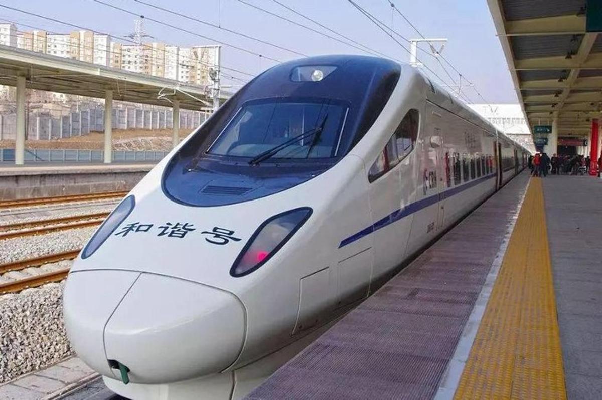 a white train is parked at a train station