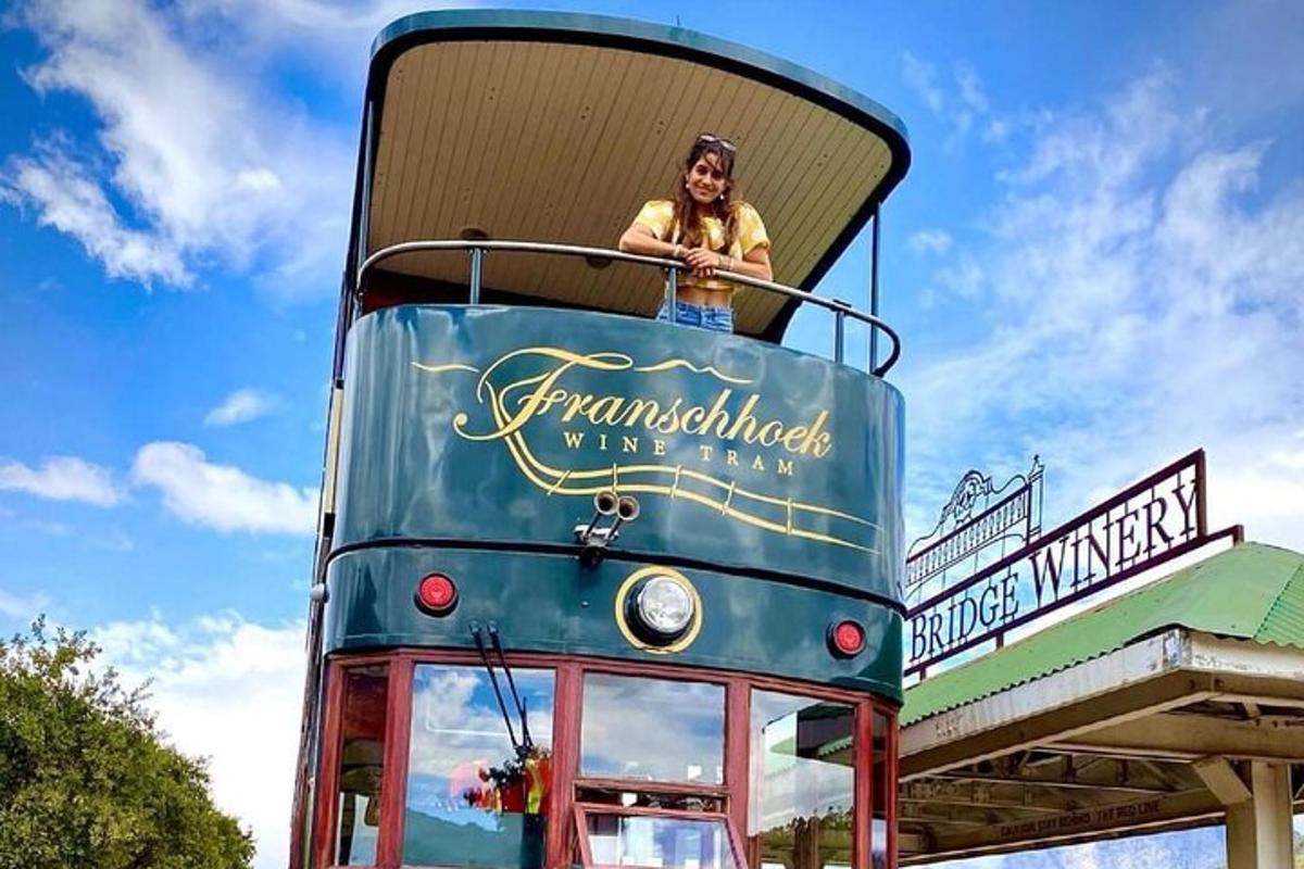 žena sedící na střeše dvoupatrového autobusu