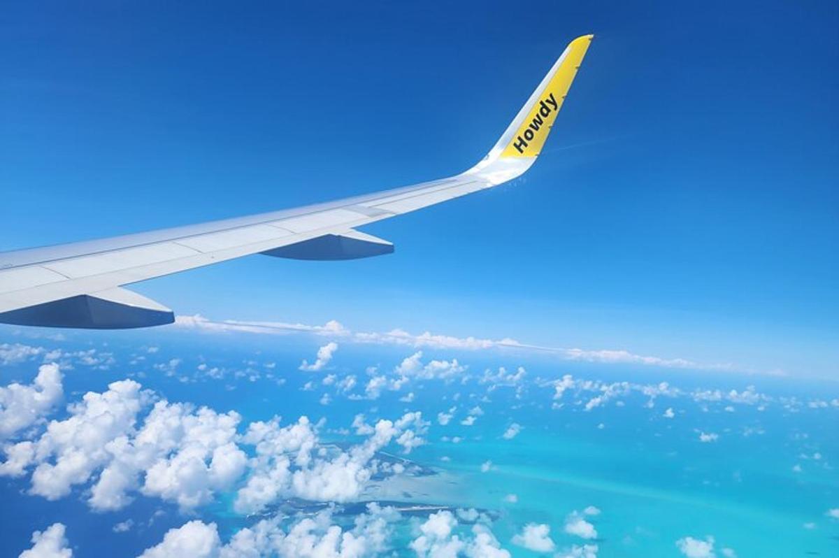 một góc nhìn về cánh của một chiếc máy bay đang bay trên đại dương