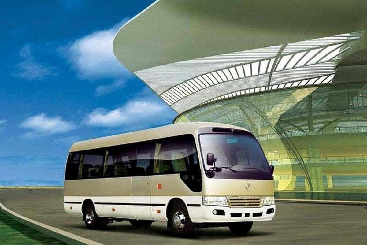 a white bus parked in front of a building