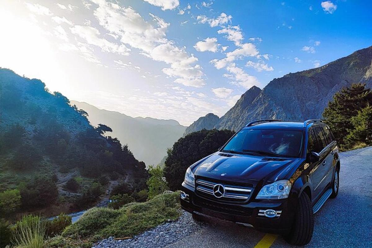 a blue suv parked on a mountain road