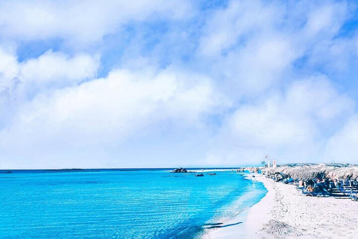 a view of a beach with blue water and rocks