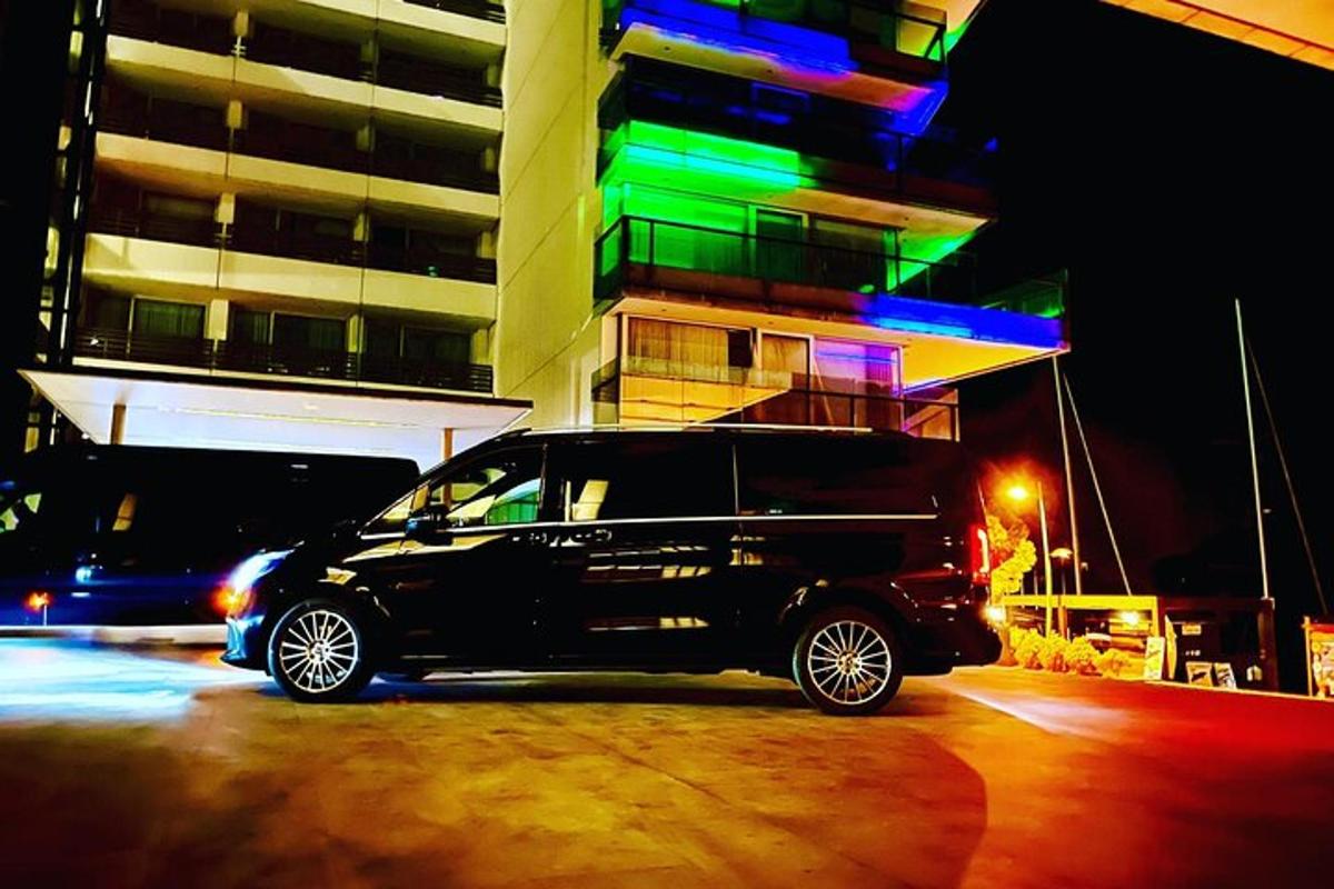 a black van parked in front of a building at night