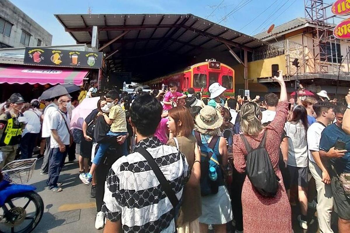 a crowd of people standing in front of a train