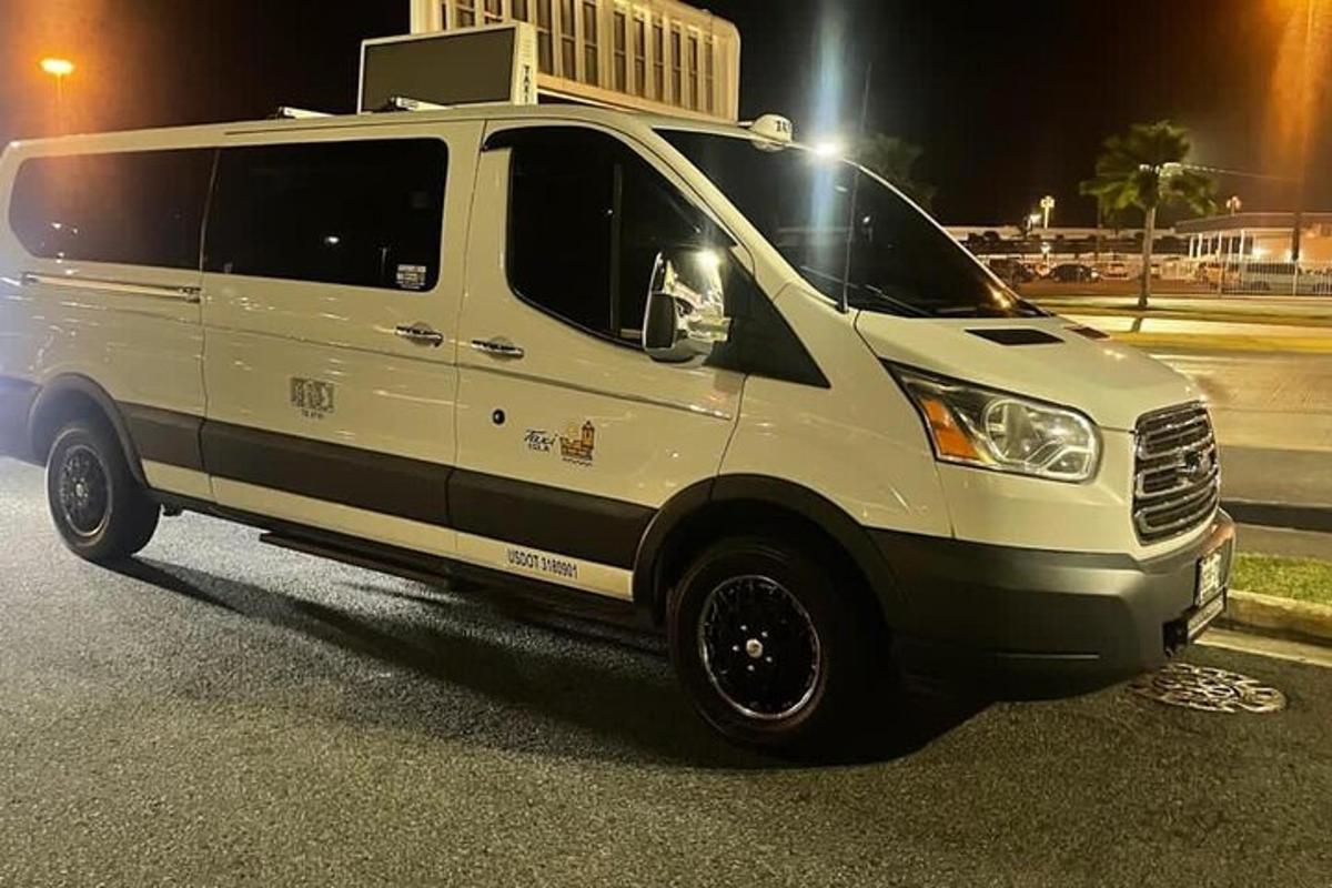 a white van parked in a parking lot at night