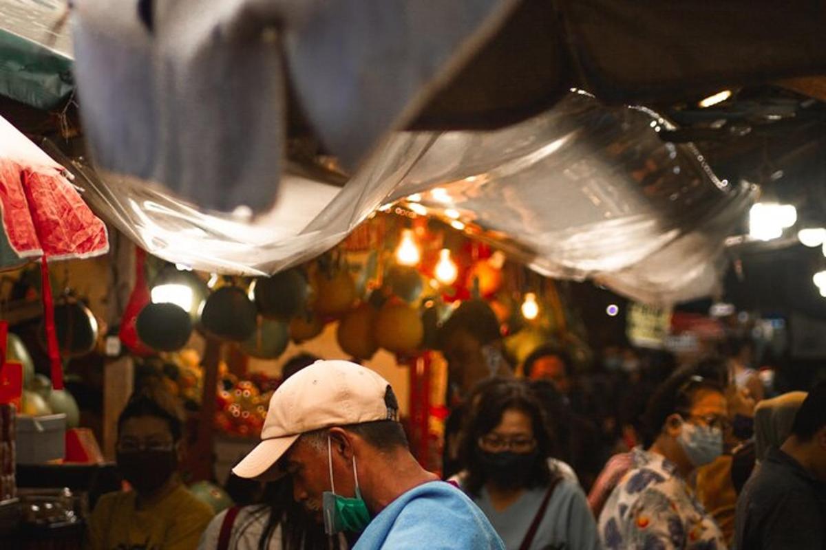 a group of people walking in a market