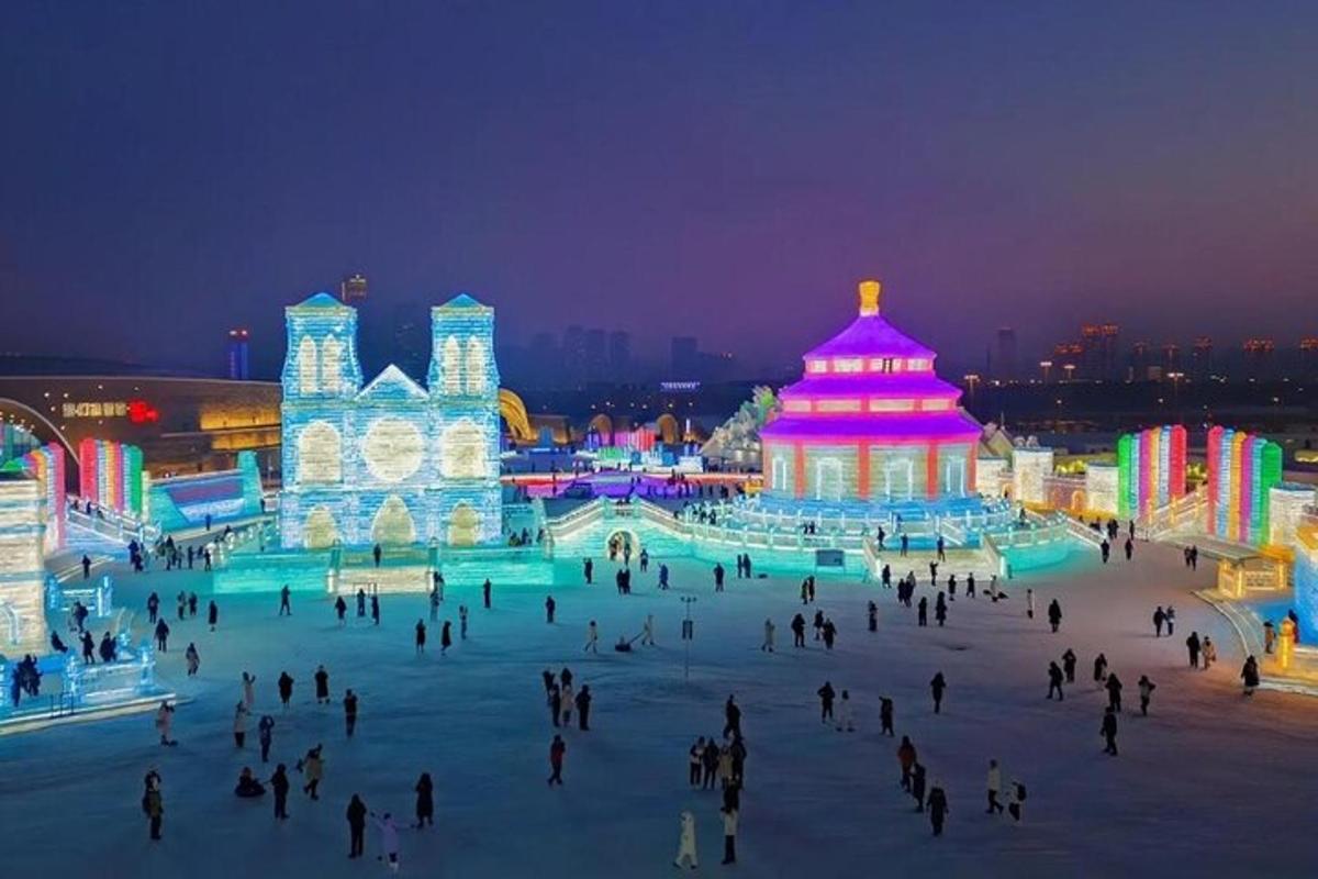 a group of people walking around an ice rink at night