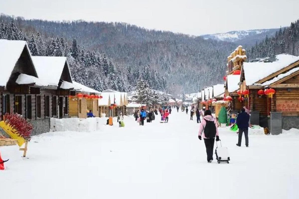 a group of people walking through a snow covered market