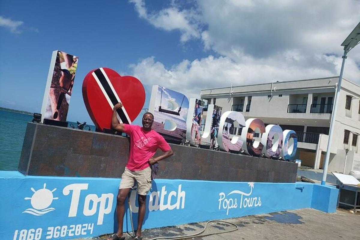 a man standing next to a wall with a surfboard