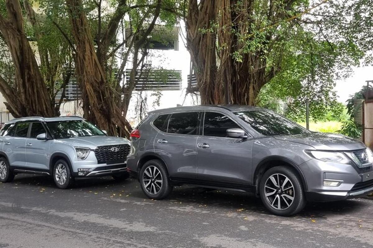 two cars parked next to each other on a street