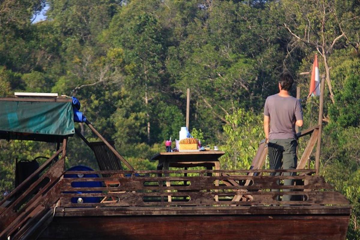 a man standing on a wooden bridge with a table