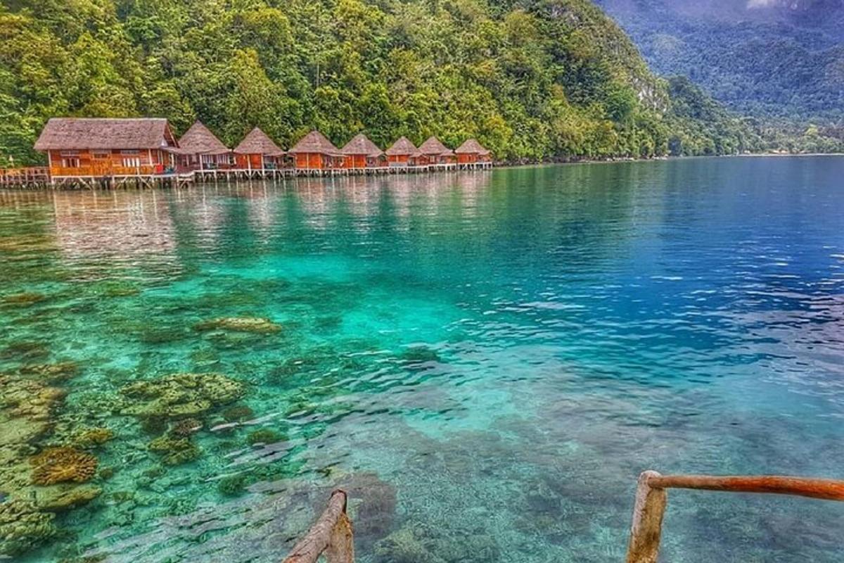 a large body of water with a group of huts