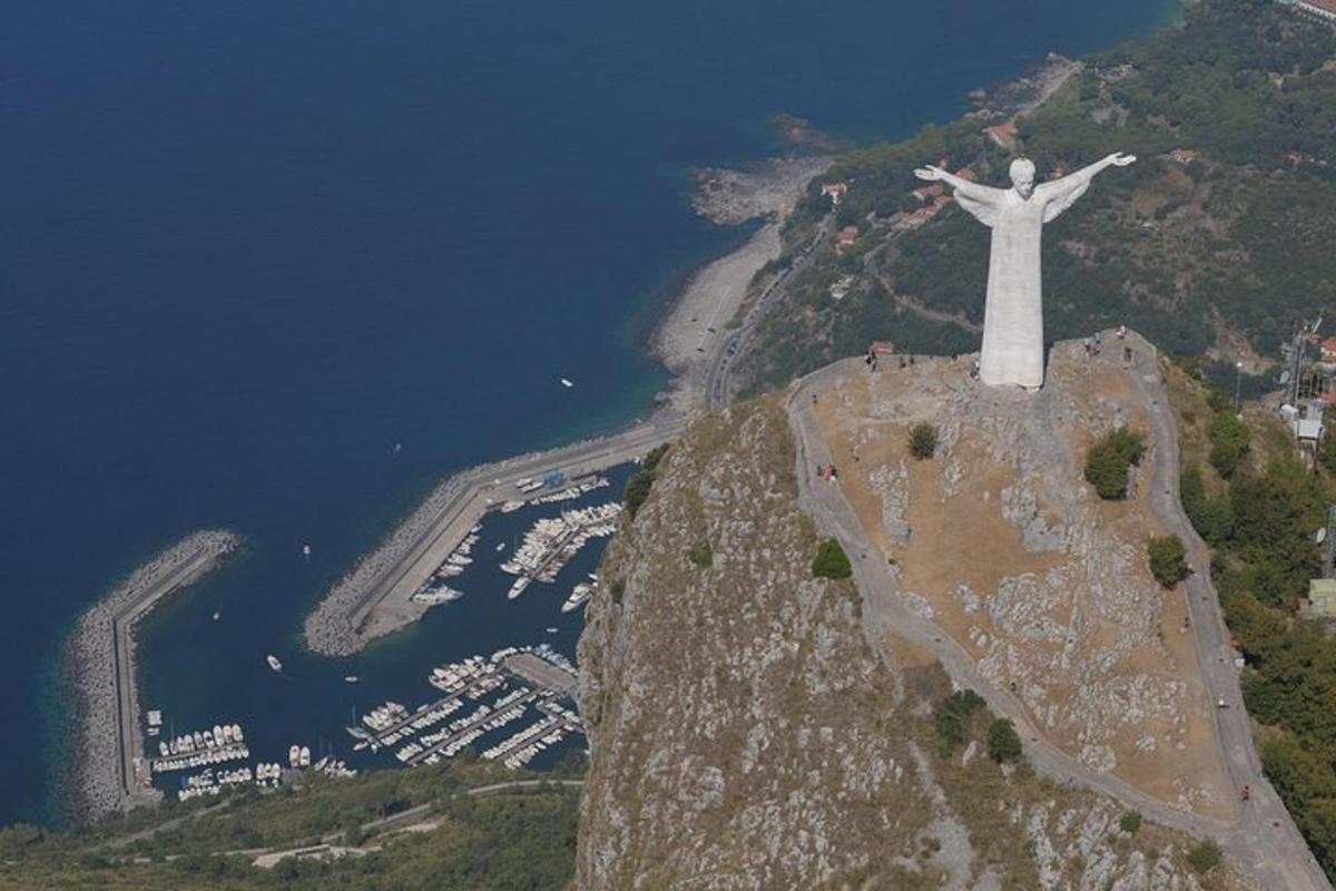 a statue of christ the redeemer on top of a mountain