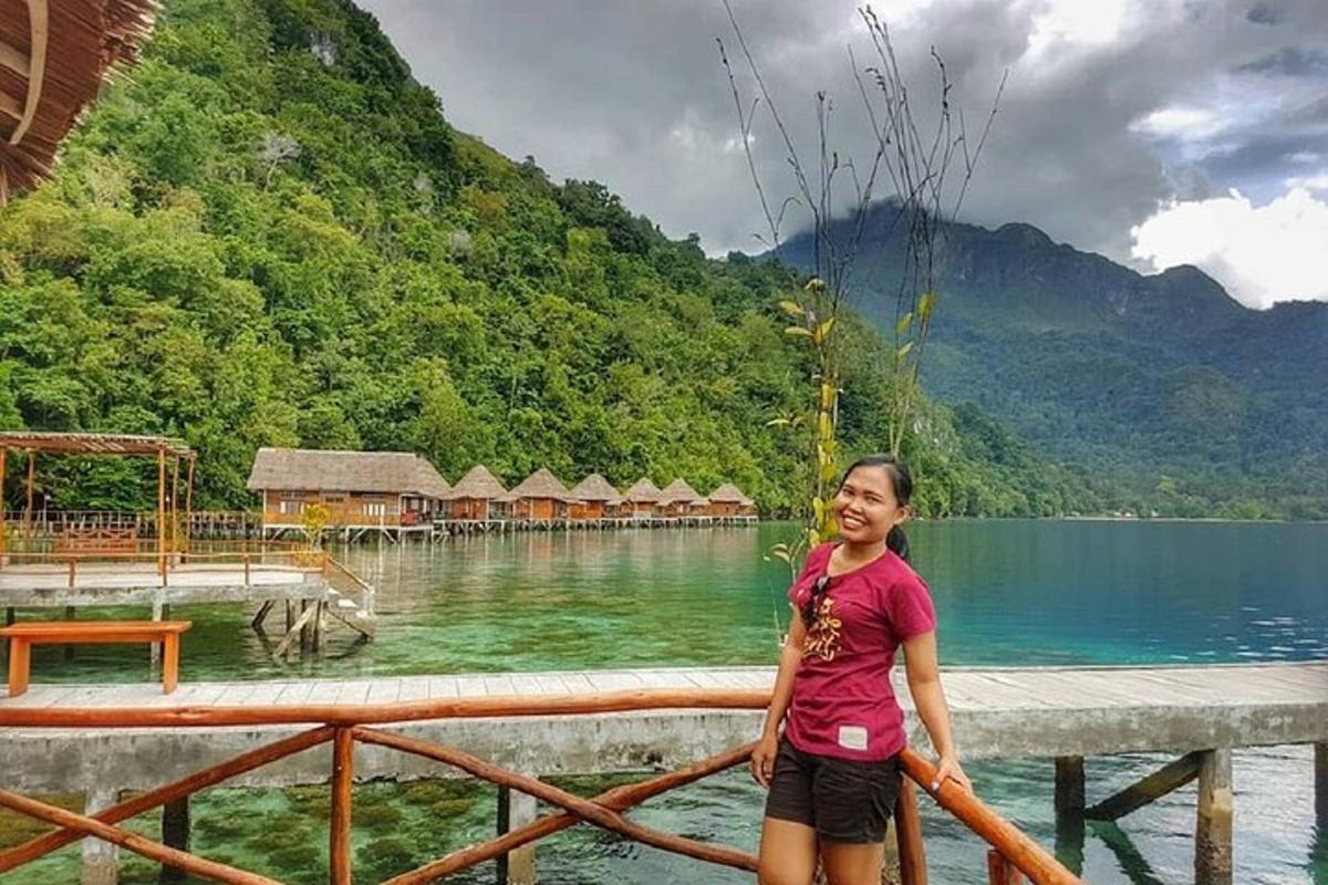 a woman standing on a pier near a body of water