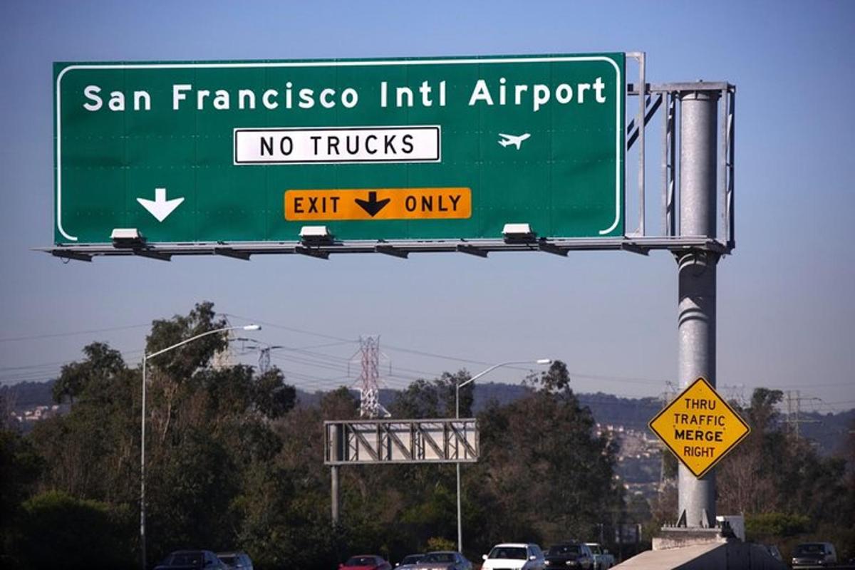 a green street sign on a highway