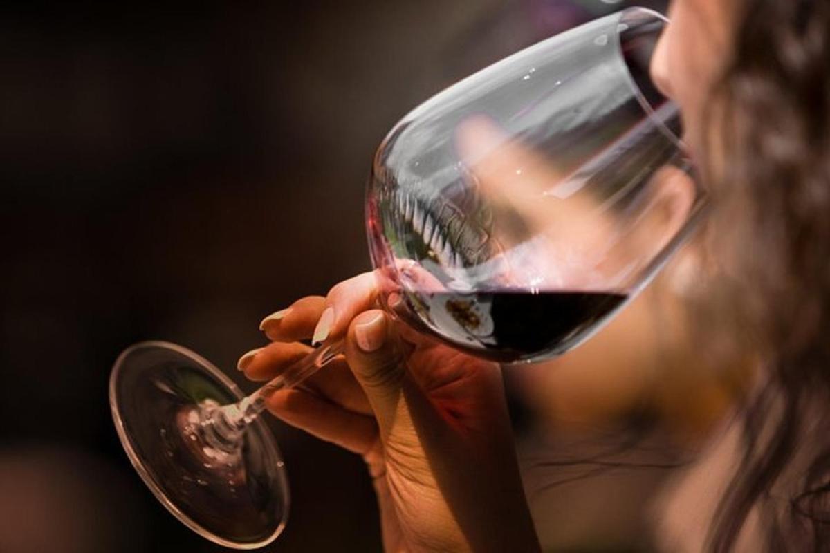 a woman holding a glass of red wine