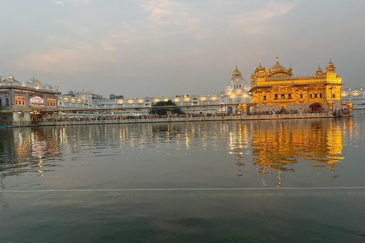 a large yellow building with lights on the water