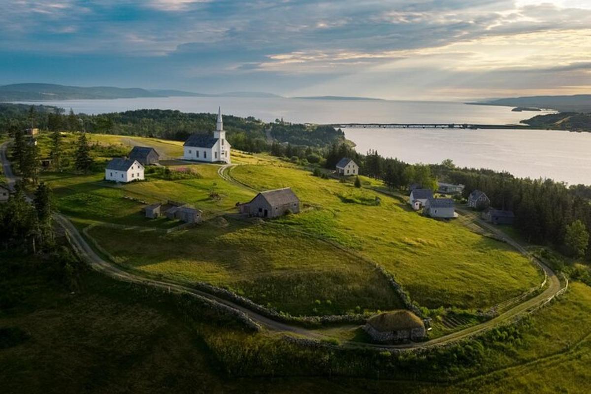 an island with a church on top of a grass field