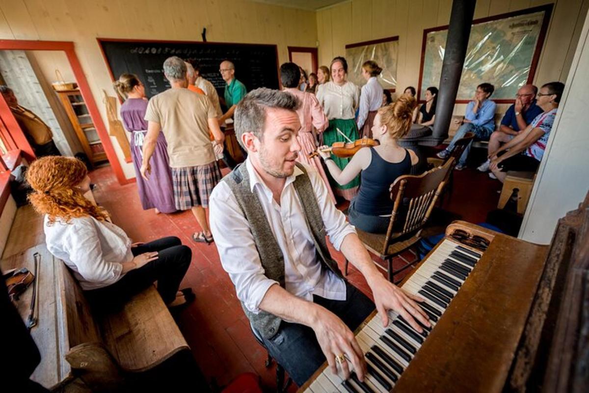 a man playing a keyboard in a room with people