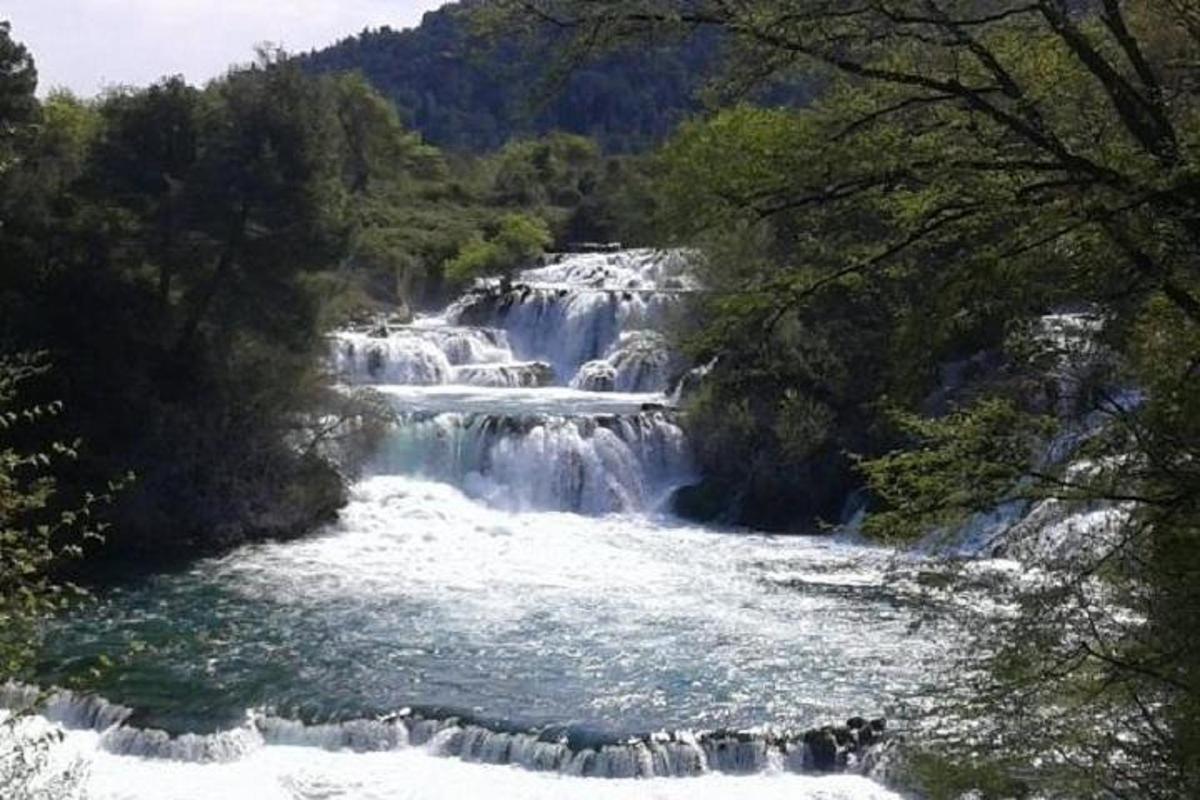 a group of waterfalls in the middle of a river