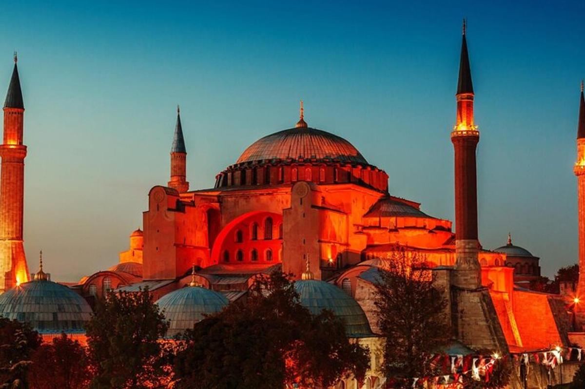 a large building with domes and mosques at night