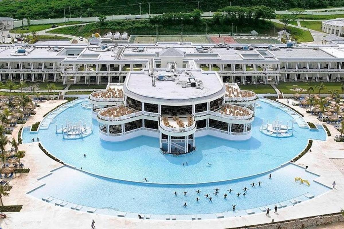 an aerial view of a large building with a pool