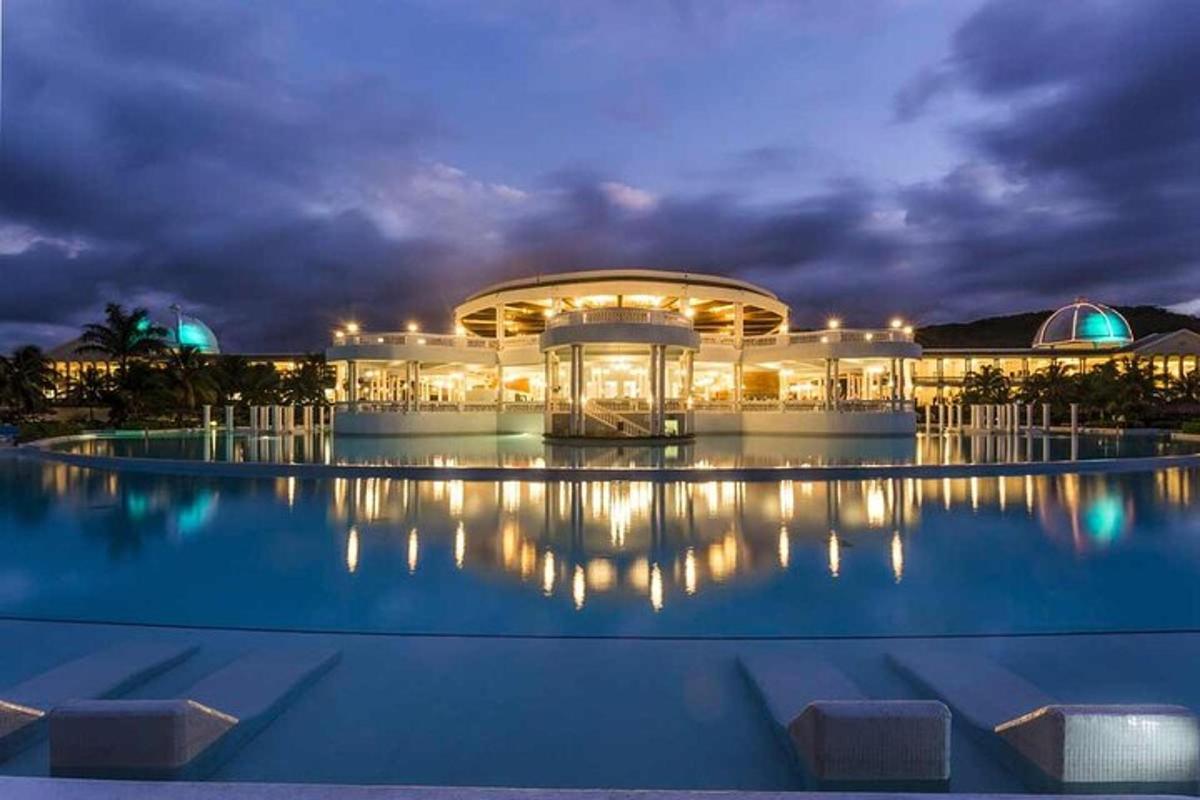 a large building with a pool at night
