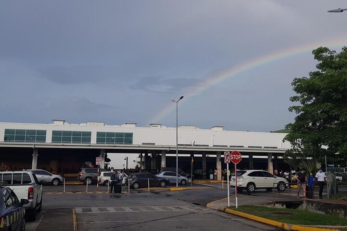 a rainbow over a parking lot with cars parked