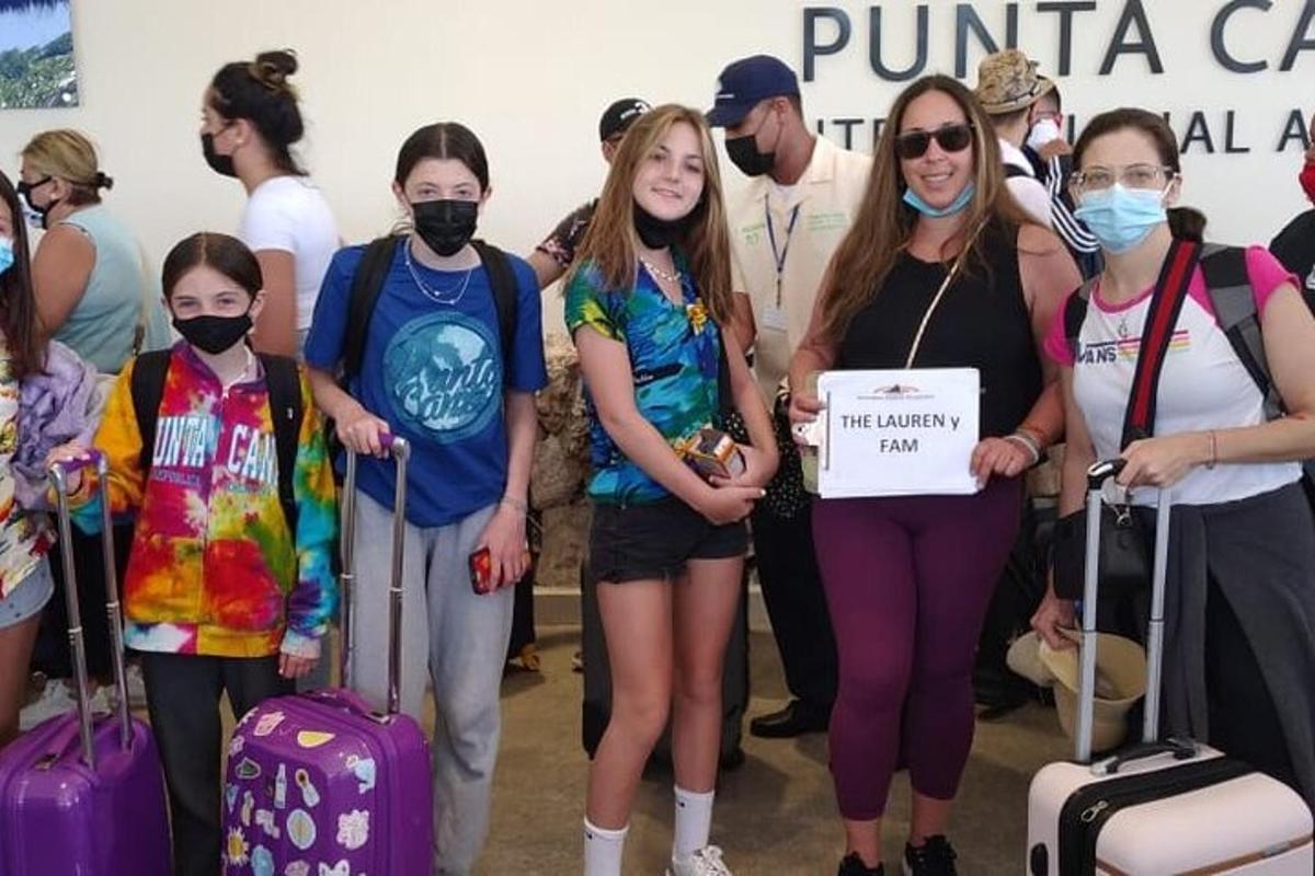 a group of people wearing masks and holding a sign