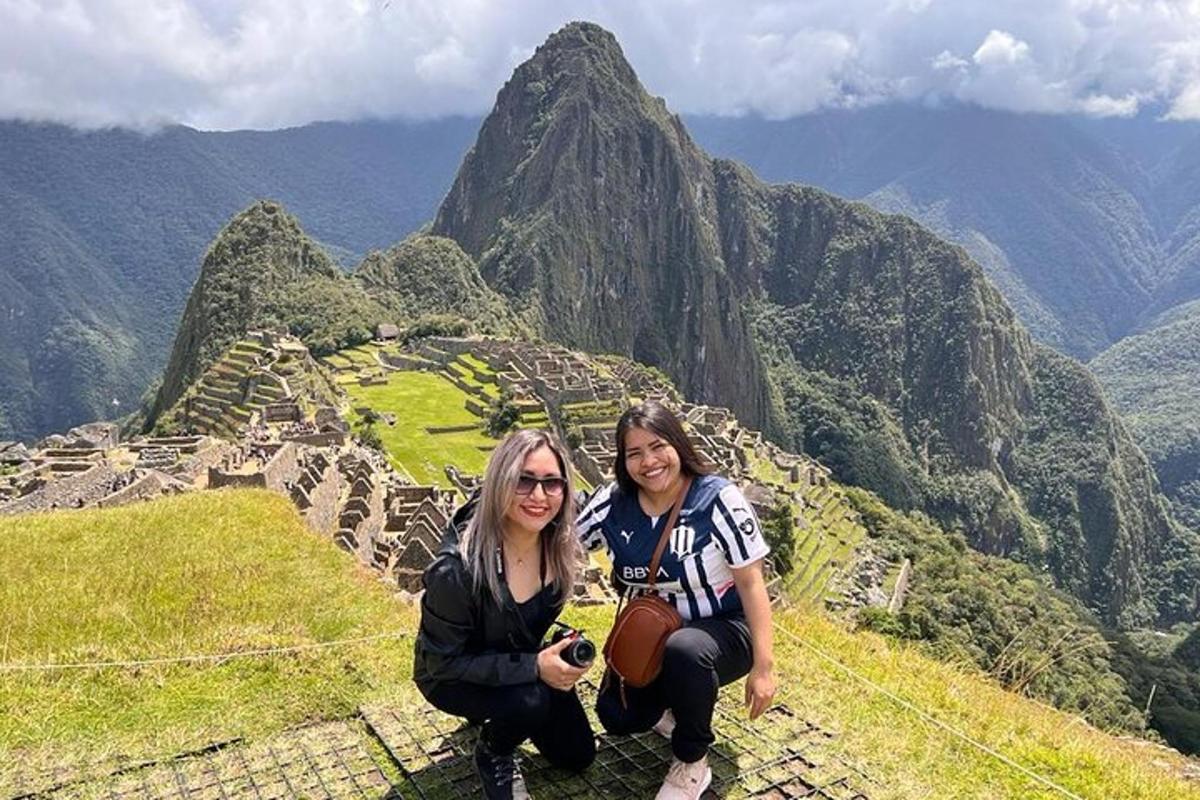 two women sitting on top of a mountain
