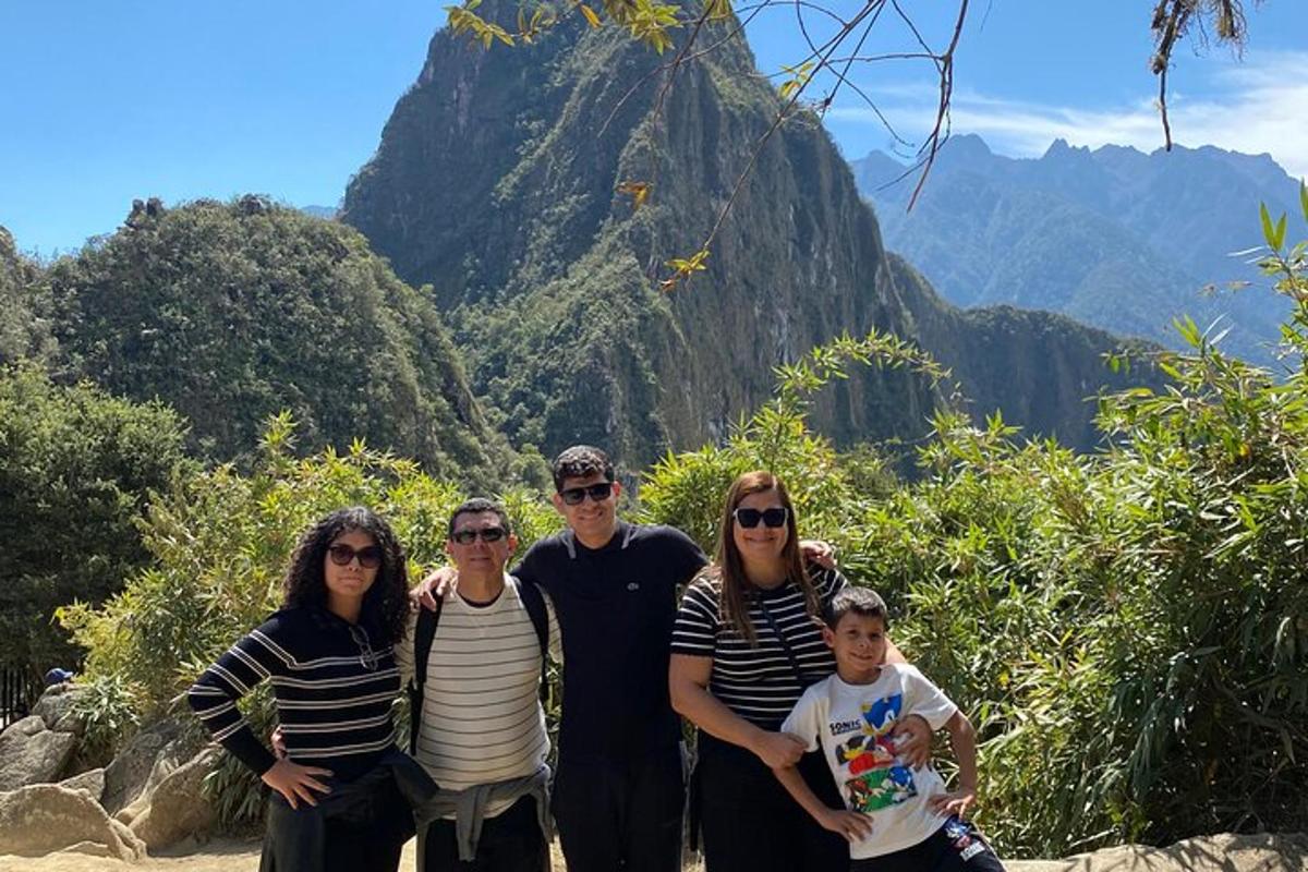 a family posing for a picture in front of a mountain