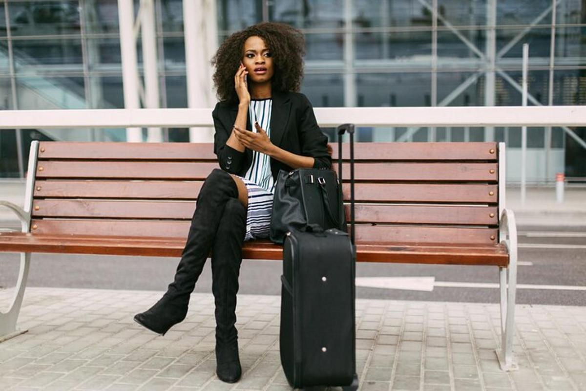 a woman sitting on a bench talking on a cell phone