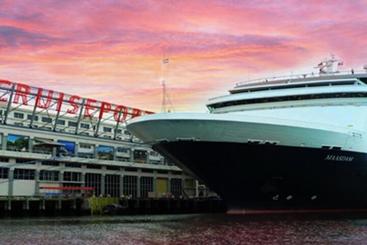 a cruise ship docked in the water with a sunset
