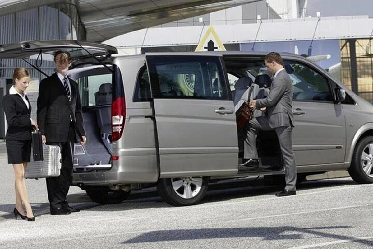 a group of people standing outside of a van