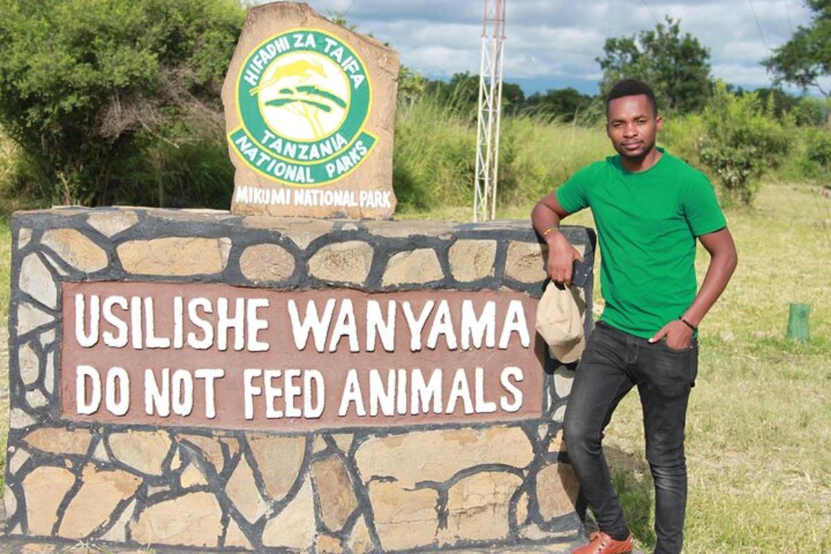 a man is standing in front of a sign
