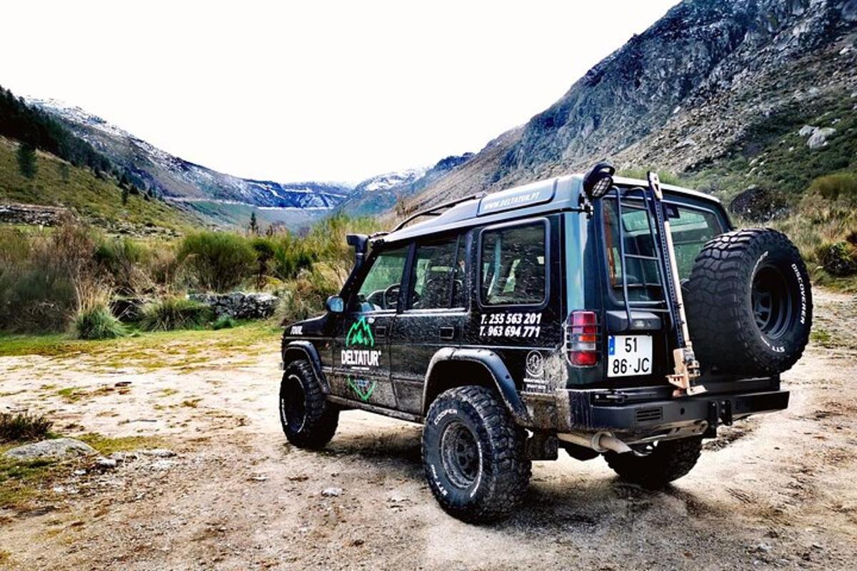 a black jeep parked on a dirt road